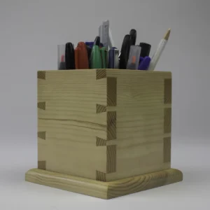 A pen cup shown at a three quarter angle to showcase both faces of the dovetails.